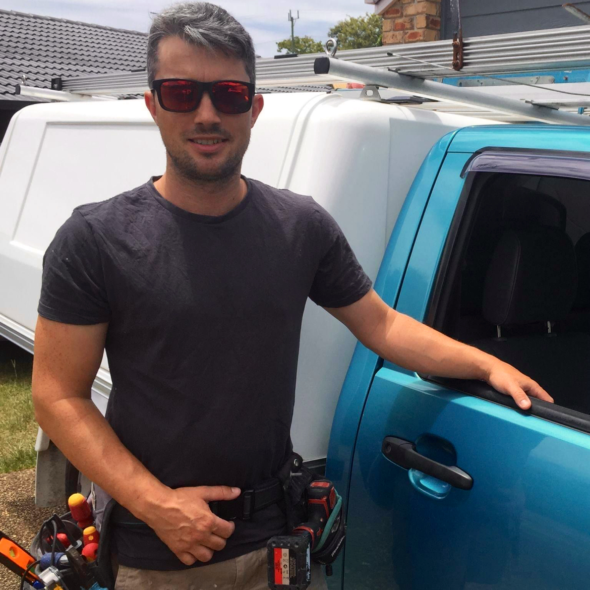 Donny Hegarty standing beside his ute with his tool belt on