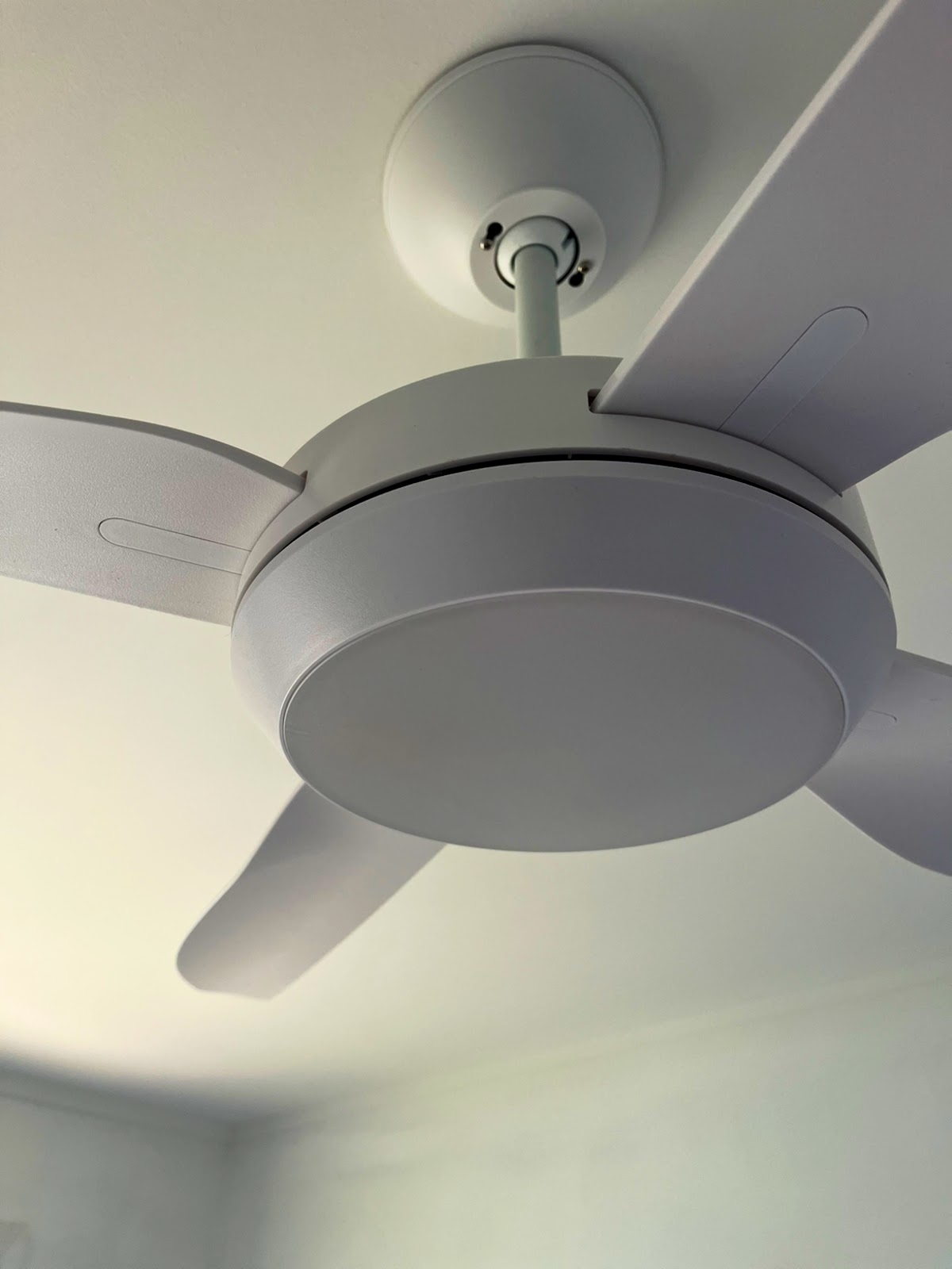 Close up of a white ceiling fan with a light