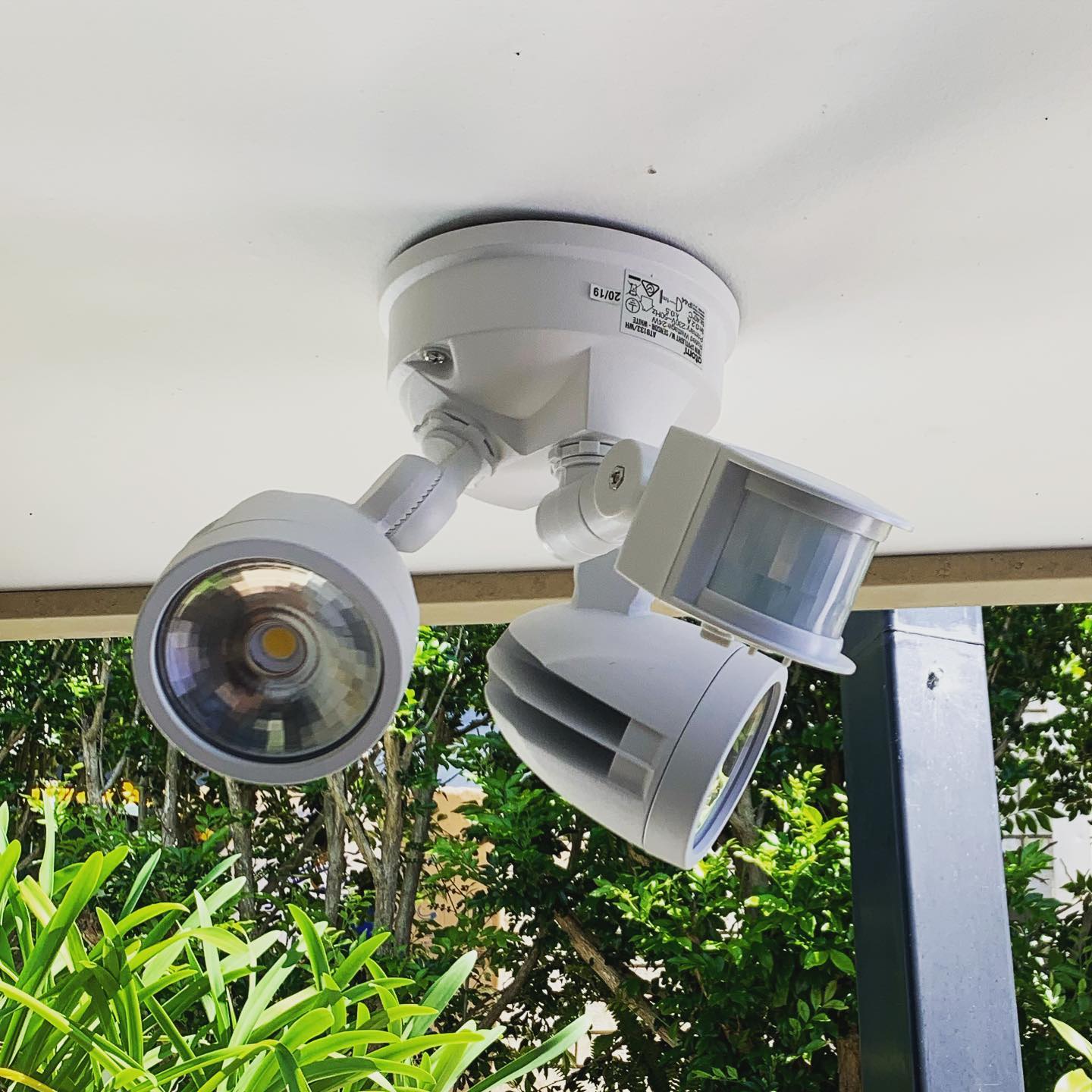 Twin spot LED sensor light mounted under a patio roof