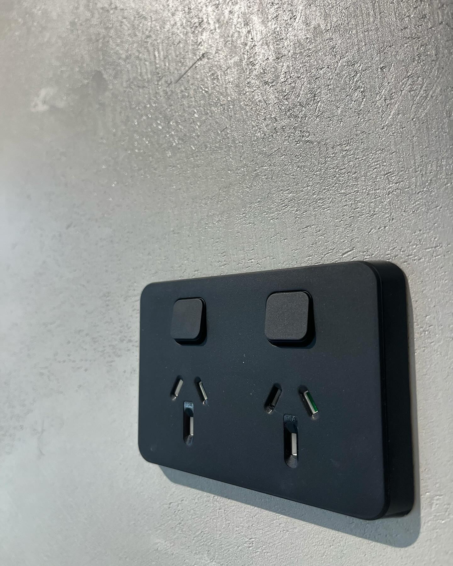 Black Clipsal Iconic double power point on a rendered wall